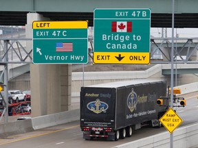 A commercial truck heads for the Ambassador Bridge at the international border crossing that connects with Windsor and Detroit. (REUTERS)