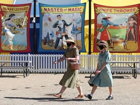 Historical interpreters walk through the renovated 1920's-style midway at Fort Edmonton Park.