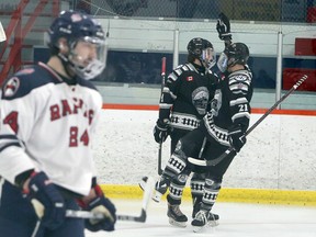 Luke Bibby (9) and Josh Boucher (21) of the Espanola Express celebrate a first-period goal against the French River Rapids during NOJHL action at Noelville Community Centre on Tuesday, February 23, 2021.