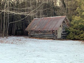 A log cabin sits on a Thrasher Road property on which the owner proposes to create a faith-based residential transition home for people with mental health conditions, addictions, and "life-controlling problems."