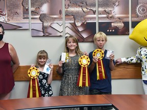 Mayerthorpe Mayor Janet Jabush, left, and Lemmy of CFYE, right, presented all three of Mayerthorpe’s awards to Cybil, Capri and Von Boll. The Bolls won Best Tasting Lemonade, Best Lemonade Stand and Local Entrepreneurs of the Year for their business When Life Gives You Lemons.