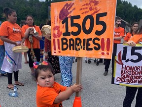 The daughter of Catrina Owl, Katana whose spirit name is Mother Turtle who guides Thunderbirds holding a sign at the SRFN demonstration.