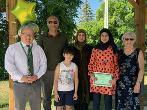 Gazal (red shirt) graduated Grade 8 at KDSS on Monday, June 28, alongside her family, her principal Mark Ozorio (L) and Judy Watt, who was representing the Refugee Committee. Gazal is the first of her family to graduate since coming to Canada. Hannah MacLeod/Kincardine News