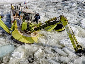An Amphibex breaks up the ice on the Rideau River in Ottawa on March 4, 2013. Chris Mikula/Postmedia Network