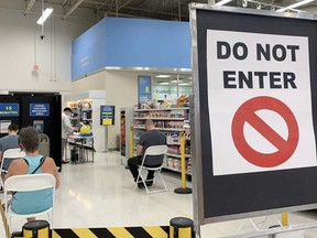 Three people wait for 15 minutes each in the recovery area following their COVID-19 vaccinations at Superstore on Baseline Road. On Friday, July 9, Alberta Health reported that 70,465 Strathcona County residents were immunized with at least one dose of COVID-19 vaccine. There were also 12 active cases reported in Strathcona County on Friday — seven in Sherwood Park and five in the rural area. Lindsay Morey/News Staff