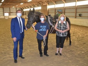 Bruce-Grey-Owen Sound MPP Bill Walker, Georgian Riding Association for Challenged Equestrians President Renee Robins and Ontario Minister of Heritage, Sport, Tourism, and Culture Industries Lisa MacLeod with Black Beauty at Wicklen Stables in Georgian Bluffs on Monday, July 12, 2021.