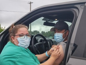 First in line, Rob Drury of Saugeen Shores was eager and willing to roll up his sleeve for Grey Bruce public health RPN Danielle McNabb to give him a COVID vaccination (his second) at a pop-up drive-through/walk-in clinic July 9 in the parking lot at the Port Elgin Plex.