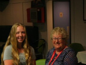 Shelby Giesbrecht accepting the scholarship cheque from club co-president Pauline Broddle