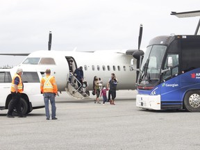 Pikangikum First Nation evacuees began arriving at Timmins Victor M. Power Municipal Airport Wednesday afternoon after being forced to flee their northwestern Ontario community due to forest fires raging in that part of the province. Sudbury took into 500 evacuees on Thursday. Postmedia photo