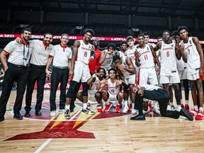 Laurentian Voyageurs head coach Shawn Swords, third from left, poses for a photo with Canada's bronze medal-winning entry in the FIBA U19 Men's World Cup in Riga, Latvia on Sunday, July 11, 2021.