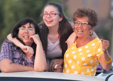 Lindsay DuBois, her daughter Lily DuBois and her mother Pam Miceil enjoy Mustang Heart at Rotaryfest on Friday, July 16, 2021 in Sault Ste. Marie, Ont.  (BRIAN KELLY/THE SAULT STAR/POSTMEDIA NETWORK)