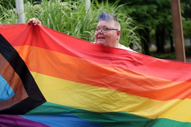 Sault Pride chair Susan Rajamaki displays The Progress Flag during Sunday morning’s Pridefest flag-raising event at the Ronald A. Irwin Civic Centre. Like many of its counterparts, Sault Pride has adopted the more inclusive symbol. Please see www.saultstar.com for photo gallery. JEFFREY OUGLER/THE SAULT STAR/POSTMEDIA NETWORK