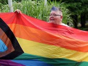 Sault Pride chair Susan Rajamaki displays The Progress Flag during Sunday morning’s Pridefest flag-raising event at the Ronald A. Irwin Civic Centre. Like many of its counterparts, Sault Pride has adopted the more inclusive symbol.  JEFFREY OUGLER/THE SAULT STAR/POSTMEDIA NETWORK.