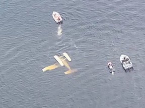 Police and water rescue crews come to the aid of a pilot whose float plane crashed on Lake Wanapitei on Sunday.