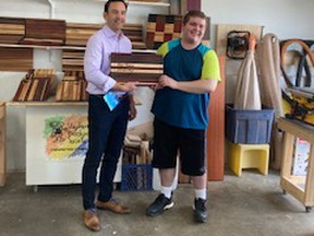 Stephen Mcphee presents MP Blake Richards with a custom-engraved cutting board in thanks for the years of support.