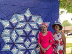 Mary Boyle stands with friend and crafting partner, Suzanne Irwin, in front of their first quilt that they made, entitled "Chrysallis". Hannah MacLeod/Lucknow Sentinel