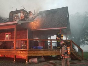 Firefighters are seen, Monday night, at the scene of a house fire on Sunnyside Road in Bonfield. A possible lightning strike is suspected to be the cause. Submitted Photo