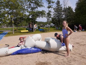 Clear Lake beach lifeguards, Connor Phillips and Erika Brown and supervisor Bailey Bouwmeester, have to deflate the big 'floaty' every afternoon at 4 pm so it can be locked up securely for the night.