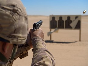 The Canadian military's plan to replace its 1940s-era Browning handguns, shown in this 2015 photo being used by Canadian troops in the Middle East, has been paused after a complaint from a firm representing a major gun manufacturer. PHOTO BY CANADIAN FORCES