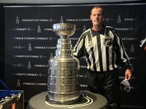 Copper Cliff native and NHL linesman David Brisebois poses beside the Stanley Cup during the 2021 final.