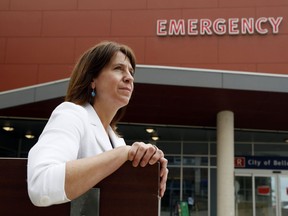Quinte Health Care president and CEO Stacey Daub sits outside the emergency department of Belleville General Hospital. A major surge in patients in the department comes at a time when the corporation is already operating beyond the extra capacity funded by Ontario