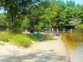 Swimmers and sunbathers enjoy the beauty and clean water at Massey's Mouth Park.