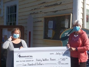 Jordan Jarvis, Globotech, presents Sylvia Leigh with a cheque for $500. The money will go towards the refurbishment of the Walker House. SUBMITTED