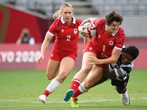 Canada's Brittany Benn of Napanee is tackled by Fiji's Ana Maria Naimasi in a women's pool B rugby sevens match between Canada and Fiji during the 2020 Tokyo Olympic Summer Games at Tokyo Stadium on Thursday.