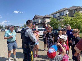 Parkland RCMP officer Stirling John stopped by a block party in Spruce Ridge on Saturday, Jul. 24, 2021, to entertain the neighbourhood kids. Photo by Melissa Mackey.