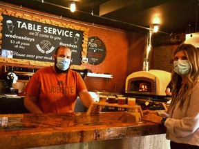 April Murray, the marketing and media lead at Destination Stratford, orders a flight of local, craft beers from co-owner Phil Buhler at Jobsite Brewing Co. in Stratford, one of 15 unique stops in Stratford, St. Marys and Shakespeare highlighting Perth County pork and local beer on Stratford's Bacon and Ale Trail, which has just started up again after a long pandemic pause. Galen Simmons/The Beacon Herald/Postmedia Network