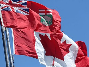 The Manitoba and Canadian flags fly on a windy day, in Winnipeg. Tuesday, July 14/2020. PHOTO BY CHRIS PROCAYLO /Winnipeg Sun