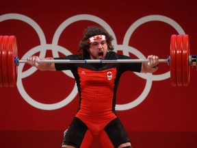 Canada's Boady Santavy of Sarnia, Ont., competes in the men’s 96-kg weightlifting competition at the Tokyo International Forum during the Tokyo Olympics on July 31, 2021, in Tokyo, Japan. (Chris Graythen/Getty Images)