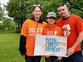 Billy Bannick, 37, of Cape Croker ran from Neyaashiinigmiing to Wiarton during his leg of a Canada Day, July 1, 2021, relay, inspired by a community need to take action in the wake of the discovery of hundreds of unmarked graves at former residential schools in B.C. and Saskatchewan. With him are fiancee, Rikki-Leigh Jacobs, and their daughter, Billie Jones.