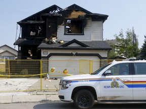 Flowers and stuffed animals left outside of fatal house fire in Chestermere Lake where 7 people died Friday on Saturday, July 3, 2021.