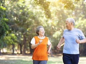 happy Senior couple running in the park