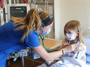 Brittany Burnham, a registered nurse with the Brant Community Healthcare System, does a checkup on Kyleigh, a five-year old pediatric patient. A renovation project for the outpatient pediatric clinic at Brantford General Hospital received a $100,000 boost on Wednesday from SC Johnson.