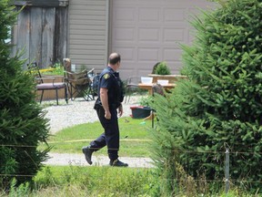 OPP officers remained on the scene Tuesday at a home in Port Burwell, where five family members, including three children, were seriously injured in a fire pit mishap. (DALE CARRUTHERS/The London Free Press)