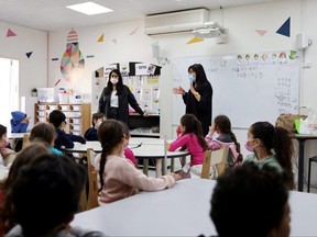 In this file photo, children sit in a classroom at their school in Mevaseret Zion, after Israel eased some COVID-19 restrictions, on Feb. 11, 2021.