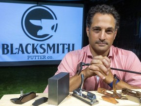Matthew Balaban, owner of Blacksmith Putter Co., shows off some of their designs, and a solid block of carbon steel from which each putter head is milled on Tuesday July 13, 2021. Balaban already runs a separate manufacturing firm in London and is now branching out in high-end, custom-made golf putters. (Mike Hensen/The London Free Press)
