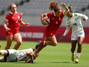 Canada's Breanne Nicholas of Blenheim, Ont., is tripped by Aline Ribeiro Furtado of Brazil during a women's rugby sevens preliminary-round game at Tokyo Stadium at the Tokyo Olympics on July 29, 2021. REUTERS/Siphiwe Sibeko