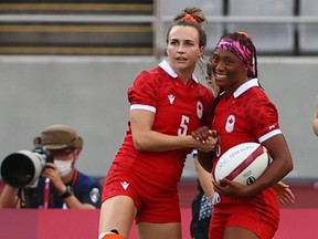 Canada’s Julia Greenshields, left, of Sarnia, Ont., and Charity Williams celebrate during a classification-round game against Brazil in women’s rugby sevens at Tokyo Stadium in the Tokyo Olympics on July 30, 2021. (REUTERS/Siphiwe Sibeko)