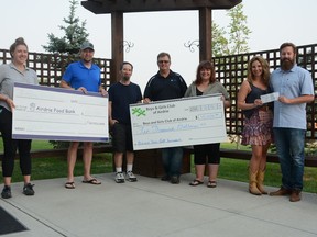 Food Bank programs manager Meghan West (from left to right), Airdrie Dads Marc Smith, Trevor Cameron and Steve Grueber, BGC Airdrie Club's Kathy Ritcher, and Nathan O'Brien Children's Foundation founders Rod and Jennifer O'Brien celebrate the success of the 2021 Airdrie Dad's Charity Golf Tournament outside of the Airdrie Food Bank on July 14. Photo by Riley Cassidy