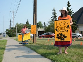 Amber Ward and Verna Shepherd stand outside Corpus Christi Church in Calgary, advocting that the TRC's 94 Calls to Action are fulfilled. Ward aims to continue her activism and begin fundraising for Indigenous-focused organizations that support people.
