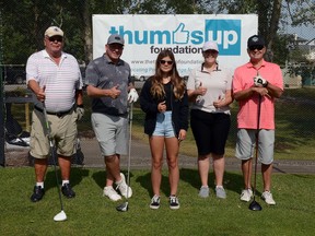 Golfers show their support with a thumbs up at the 2020 Thumbs Up Charity Golf Tournament.