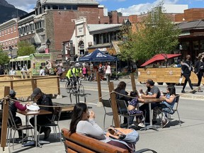 A busy Banff Avenue with open patios and visitors enjoying street dining on Saturday evening, June 12, 2021. Photo Marie Conboy/ Postmedia.