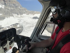 Alpine Helicopter's Sightseeing Tour Pilot Adam Fayad flies tourists to view the glacier on Assiniboine on July 13, 2021. Fayad is originally from Vancouver Island and has been flying for Alpine Helicopters since 2018. He said tourists numbers have been greatly reduced without international travel this summer. Photo Marie Conboy/ Postmedia.