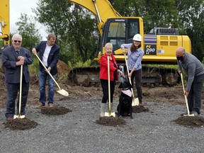 Humane Society chair Donna Endicott, centre, tries to keep canine ambassador Millie in line during a groundbreaking ceremony Friday at the site of the society's future home at 34 Wallbridge-Loyalist Road in Belleville. With them from left were Quinte West Mayor Jim Harrison, society capital campaign chair Greg Sudds, Taskforce Engineering president Hilary Murphy, and Belleville Mayor Mitch Panciuk.