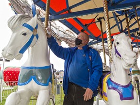Campbell Amusements ride operator Mike Legere wipes down the carousel on Thursday July 8, 2021 as preparations are underway to open a small carnival starting Friday at the Paris Fairgrounds.