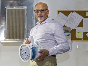 Nexnord CEO Shan Jamal holds a UVC lighting unit used in duct work that the company says is capable of eradicating the COVID-19 virus.