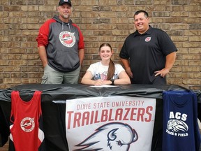 Sophia Imola has accepted an NCAA scholarship to attend Dixie State University, where she'll compete in hammer throw and discus. Imola recently celebrated her signing with Brantford Track and Field Club coaches Trevor Windle (left) and Sean Doucette.